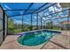 Enjoy this screened-in pool with spa and water views at 3300 Pennyroyal Rd, Port Charlotte, FL 33953