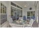 Covered patio with table, chairs, and pool view at 3300 Pennyroyal Rd, Port Charlotte, FL 33953
