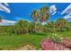 Landscaped backyard with lush tropical plants and palm trees at 3392 Pennyroyal Rd, Port Charlotte, FL 33953