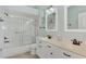 Bathroom with a double vanity, shower/tub combo and light teal walls at 3392 Pennyroyal Rd, Port Charlotte, FL 33953