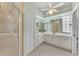 Large bathroom with double vanity, glass shower, and separate toilet area at 3392 Pennyroyal Rd, Port Charlotte, FL 33953