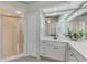 Spa-like bathroom with double vanity, large mirror, and a walk-in shower at 3392 Pennyroyal Rd, Port Charlotte, FL 33953