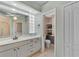 Bathroom features a double vanity, a glass-enclosed shower, and a linen closet at 3392 Pennyroyal Rd, Port Charlotte, FL 33953
