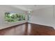 Bright bedroom with hardwood floors and large windows offering a view of nature at 3392 Pennyroyal Rd, Port Charlotte, FL 33953