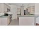 Kitchen with light wood cabinets, stainless steel appliances, and teal countertops at 3392 Pennyroyal Rd, Port Charlotte, FL 33953