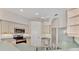 Kitchen boasts light wood cabinets, stainless steel appliances, and a breakfast bar at 3392 Pennyroyal Rd, Port Charlotte, FL 33953