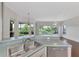 Kitchen features a breakfast bar, stainless steel appliances, and serene backyard view at 3392 Pennyroyal Rd, Port Charlotte, FL 33953