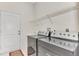 Laundry room with washer, dryer, and built-in shelving at 3392 Pennyroyal Rd, Port Charlotte, FL 33953
