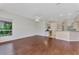 Bright living area with hardwood floors and kitchen access at 3392 Pennyroyal Rd, Port Charlotte, FL 33953