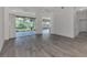 Bright living room with tile flooring, access to backyard patio, and high ceilings at 3392 Pennyroyal Rd, Port Charlotte, FL 33953
