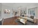 Living room with hardwood floors, and a view into the kitchen at 3392 Pennyroyal Rd, Port Charlotte, FL 33953