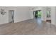 Spacious living area featuring tile flooring and access to backyard patio at 3392 Pennyroyal Rd, Port Charlotte, FL 33953