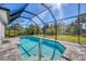 Enclosed pool and patio area with a screened-in cage at 399 Sunset N Rd, Rotonda West, FL 33947