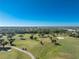 Aerial view of the golf course with lush greens and palm trees at 539 Westmount Ln, Venice, FL 34293