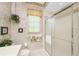 Simple bathroom with toilet, shower, and window at 539 Westmount Ln, Venice, FL 34293