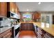 Modern kitchen featuring stainless steel appliances and wood cabinetry at 6089 Dime Ct, Port Charlotte, FL 33981