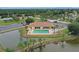 Community pool and clubhouse near lake at 6089 Dime Ct, Port Charlotte, FL 33981