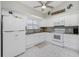 White kitchen with granite countertops and stainless steel appliances at 6546 Hamlet Dr # 17A, Englewood, FL 34224