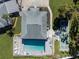 Community pool area with lounge chairs, shuffleboard courts and a clubhouse at 6546 Hamlet Dr # 17A, Englewood, FL 34224