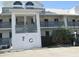 Two-story condo building with balconies and parking at 6800 Placida Rd # 179, Englewood, FL 34224