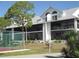 Two-story building with screened balconies and tennis courts nearby at 6800 Placida Rd # 179, Englewood, FL 34224