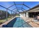 Long, refreshing pool with screened enclosure and patio furniture at 8 Windward Rd, Placida, FL 33946