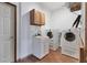 Bright laundry room with washer, dryer, and cabinets at 90 Green Dolphin N Dr, Placida, FL 33946