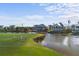 Golf course view with home and waterway in background at 10030 Eagle Preserve Dr, Englewood, FL 34224