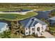 Stunning aerial view of the waterfront home and the golf course at 10030 Eagle Preserve Dr, Englewood, FL 34224