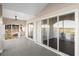 Covered balcony with sliding glass doors, offering views of the golf course and water at 10030 Eagle Preserve Dr, Englewood, FL 34224