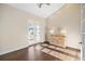 Bedroom with wood floors, double doors leading to a balcony, and natural light at 10030 Eagle Preserve Dr, Englewood, FL 34224