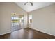 Bedroom with hardwood floors and access to a private balcony and golf course views at 10030 Eagle Preserve Dr, Englewood, FL 34224