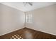 Bright bedroom with wood floors, ceiling fan, and plantation shutters at 10030 Eagle Preserve Dr, Englewood, FL 34224