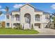 Two-story home with gray siding, metal roof, and landscaping at 10030 Eagle Preserve Dr, Englewood, FL 34224