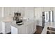 Modern kitchen with white cabinets and large island at 10030 Eagle Preserve Dr, Englewood, FL 34224