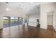 Open living room with kitchen island and golf course view at 10030 Eagle Preserve Dr, Englewood, FL 34224