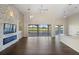 Spacious living room with stone fireplace and golf course view at 10030 Eagle Preserve Dr, Englewood, FL 34224