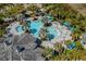 Resort-style pool with multiple lounging areas and palm trees at 11249 Mc Dermott Ct, Englewood, FL 34223