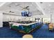 Modern bar with green tile, blue chairs and large screen TVs at 11249 Mc Dermott Ct, Englewood, FL 34223
