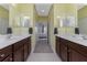 Double vanity bathroom with access to bedroom and walk-in shower at 11249 Mc Dermott Ct, Englewood, FL 34223