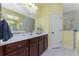 Spa-like bathroom with double vanity and a walk-in shower at 11249 Mc Dermott Ct, Englewood, FL 34223
