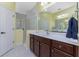 Double vanity bathroom with a large mirror and walk-in shower at 11249 Mc Dermott Ct, Englewood, FL 34223