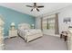 Bright bedroom with a queen bed, ceiling fan, and large window at 11249 Mc Dermott Ct, Englewood, FL 34223