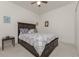 Spacious bedroom with a dark wood bed frame and patterned bedding at 11249 Mc Dermott Ct, Englewood, FL 34223