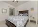 Comfortable bedroom, featuring a dark wood platform bed and window views at 11249 Mc Dermott Ct, Englewood, FL 34223