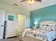 Main bedroom with teal accent wall, white dresser and queen bed at 11249 Mc Dermott Ct, Englewood, FL 34223