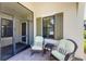 Screened porch with wicker chairs and side table at 11249 Mc Dermott Ct, Englewood, FL 34223