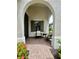 Relaxing front porch with wicker chairs and side table at 11249 Mc Dermott Ct, Englewood, FL 34223