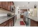 Open concept kitchen with island and stainless steel appliances at 11249 Mc Dermott Ct, Englewood, FL 34223