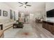 Open living room with hardwood floors, modern furniture, and a view of the kitchen at 11249 Mc Dermott Ct, Englewood, FL 34223